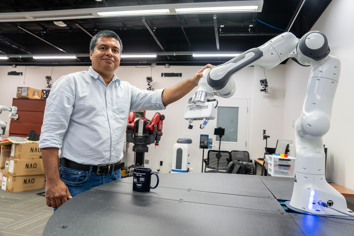Tariq Iqbal with robot arm