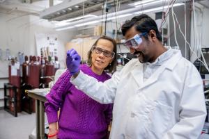 Professor interacting with grad student in materials science lab