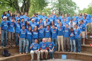 A large group of students and faculty pose wearing blue T-shirts printed with I [Heart] Gainer.