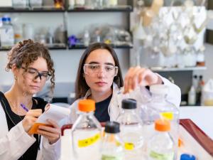 Two chemical engineering students look at samples in the lab