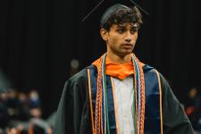 A student walks to the stage