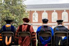 Faculty seated on the stage