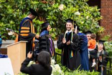Students wait to receive diplomas