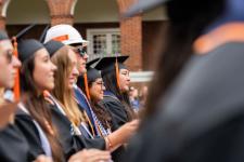 Students stand during the ceremony
