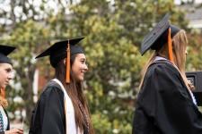 students wait to receive diplomas