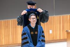 A PhD graduate is hooded
