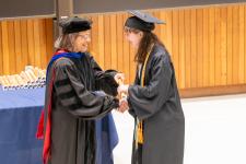 A student receives her diploma