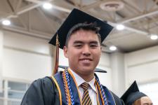 Student waits in line to receive his diploma