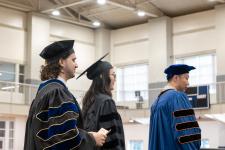Students wait in line to receive their diplomas