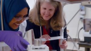 Dean Jennifer West works with a student in a lab