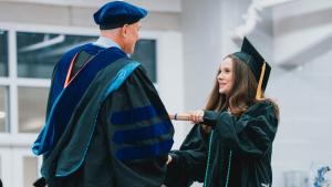 A student receives her diploma