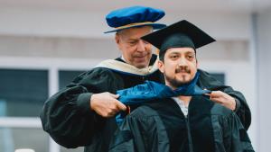 A Ph.D. student is hooded