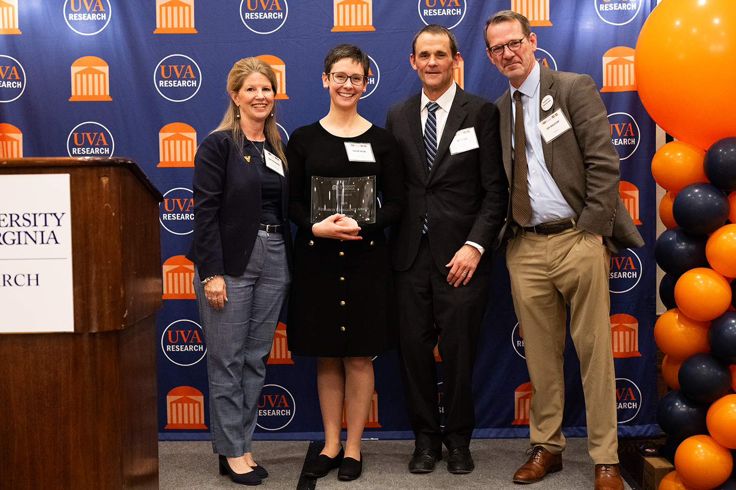Award presenters and recipients posing at an awards ceremony.