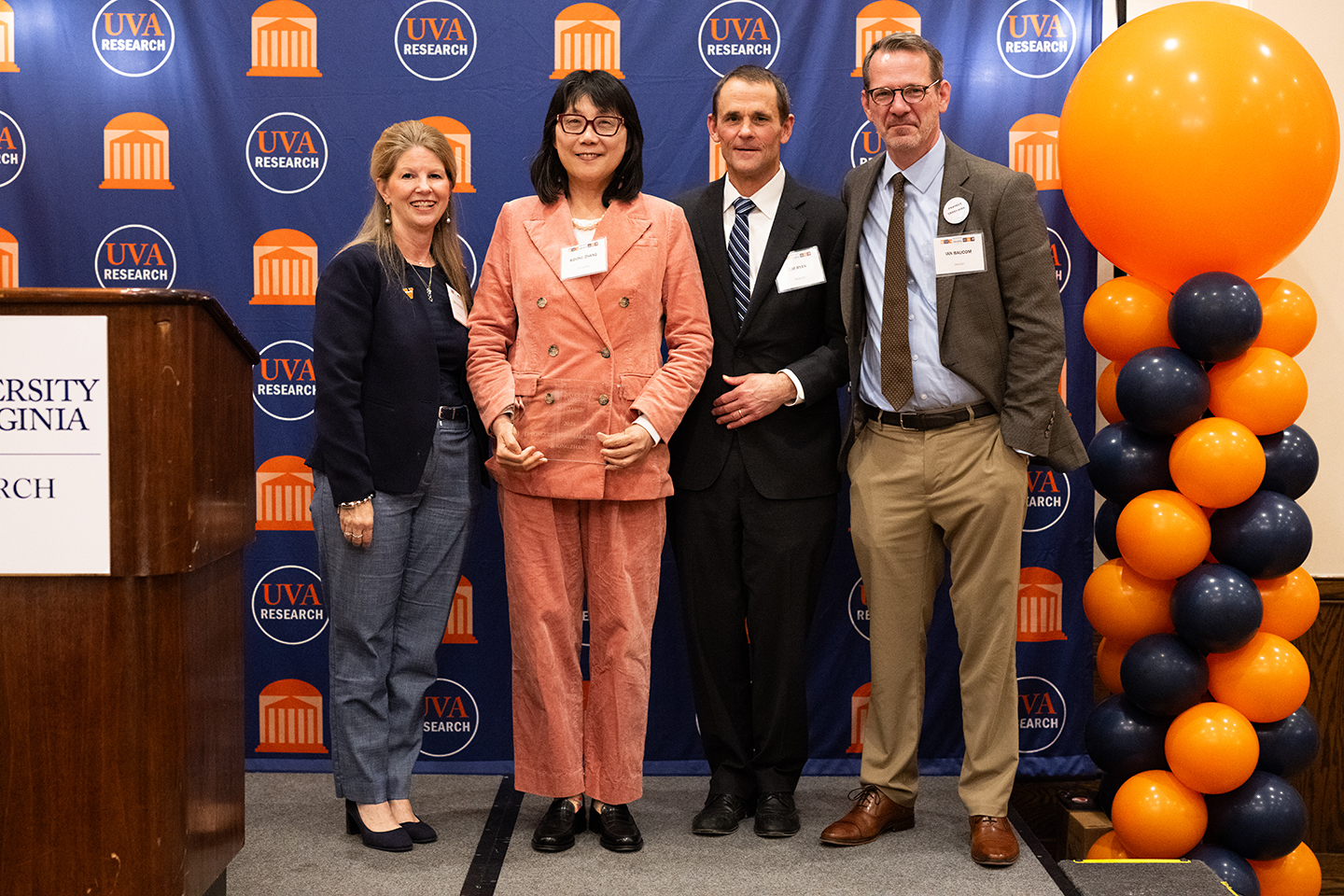 Award presenters and recipients posing at an awards ceremony.