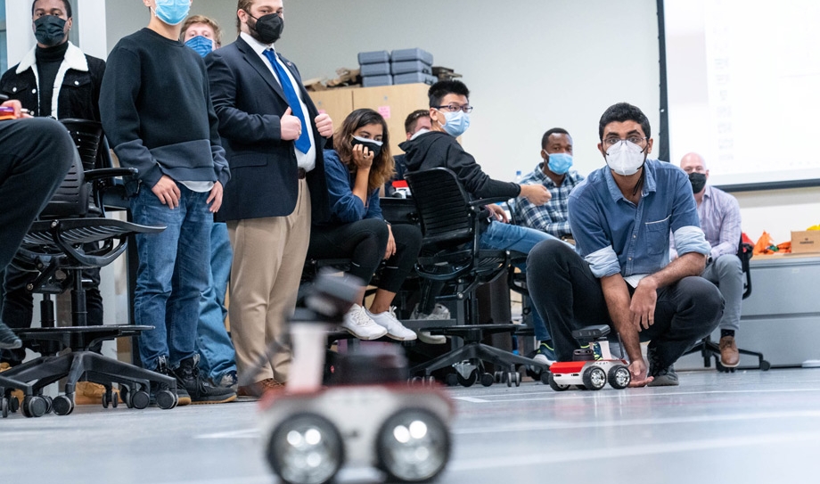 students watching the robotic cars