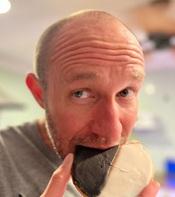 Image of man eating a big cookie