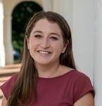 Image of Emily wearing a burgundy colored dress standing near the Rotunda