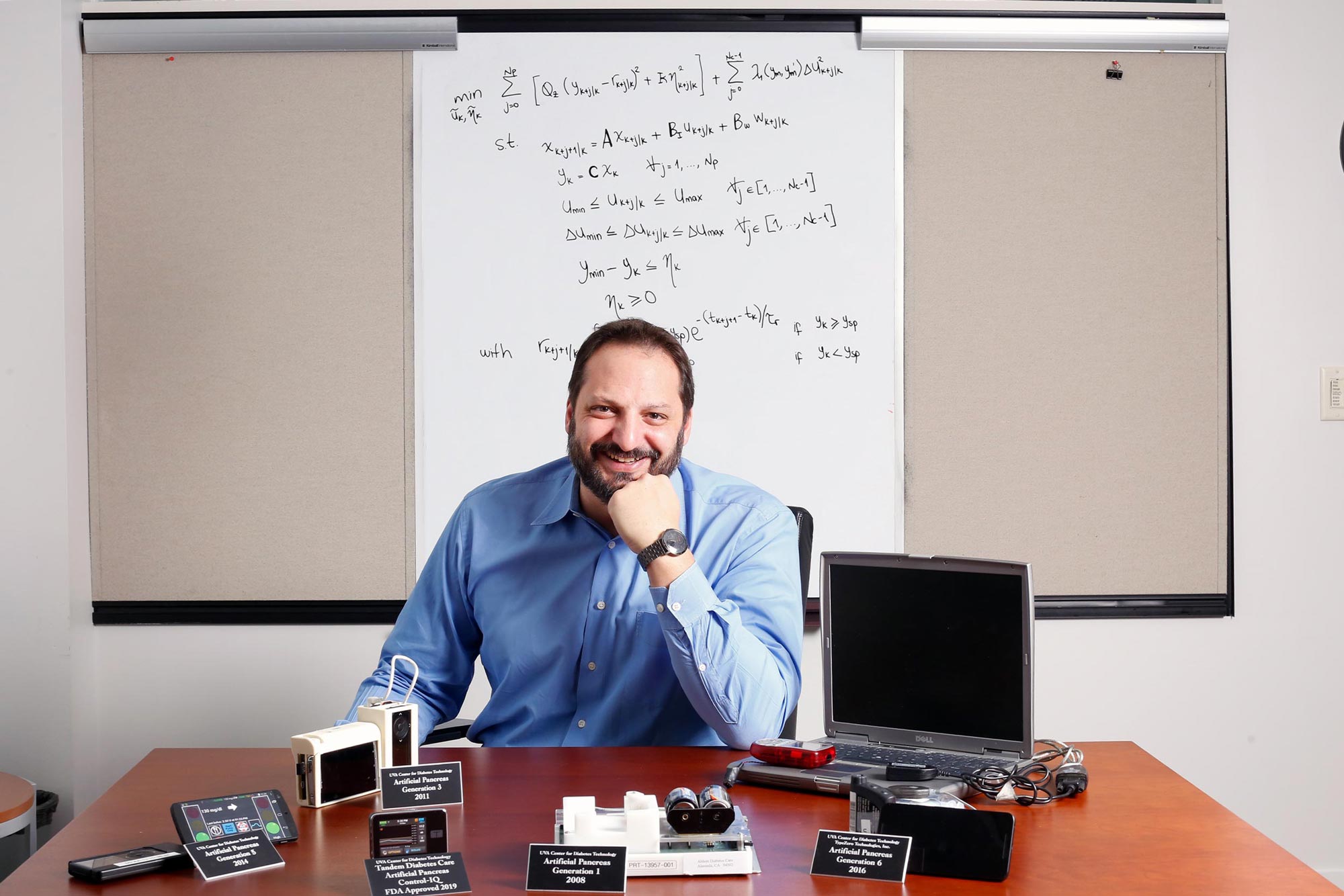Posed photo of a man sitting at a desk