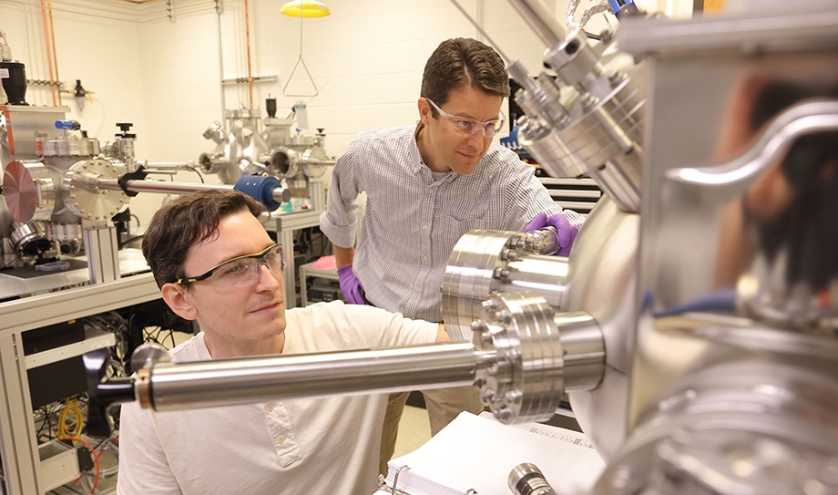 Jon Ihlefeld in the lab with a student