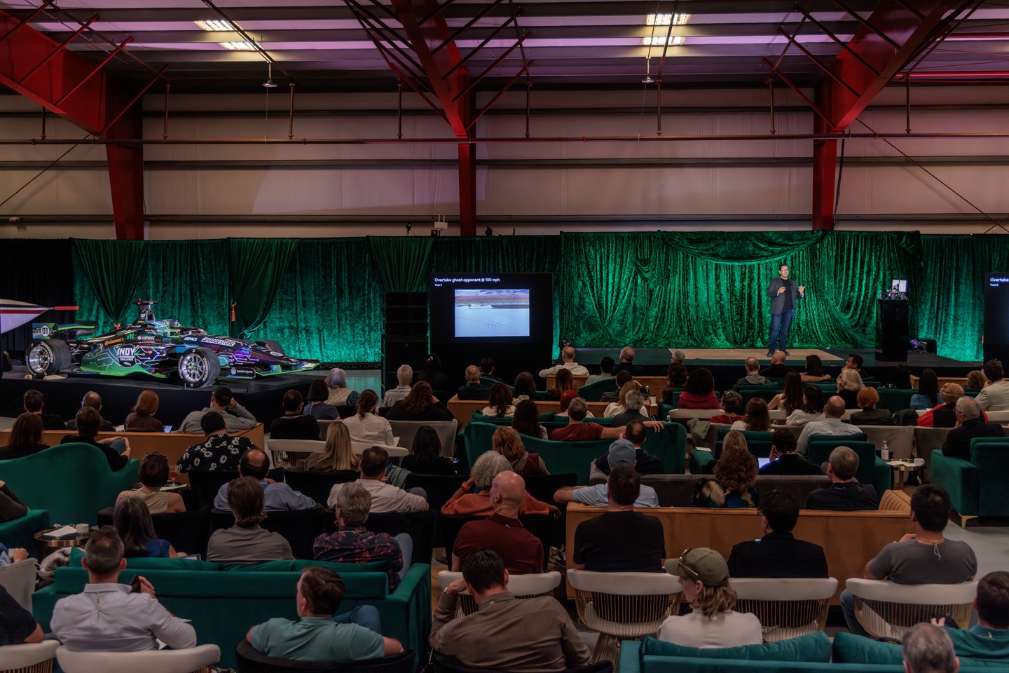 A full audience listens to Behl at the invitation-only event.