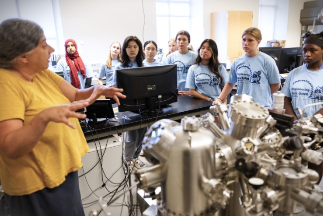 Standing near a steampunk-looking piece of equipment called a tunneling microscope, Petra Reinke discusses air, air pressure and surfaces. 