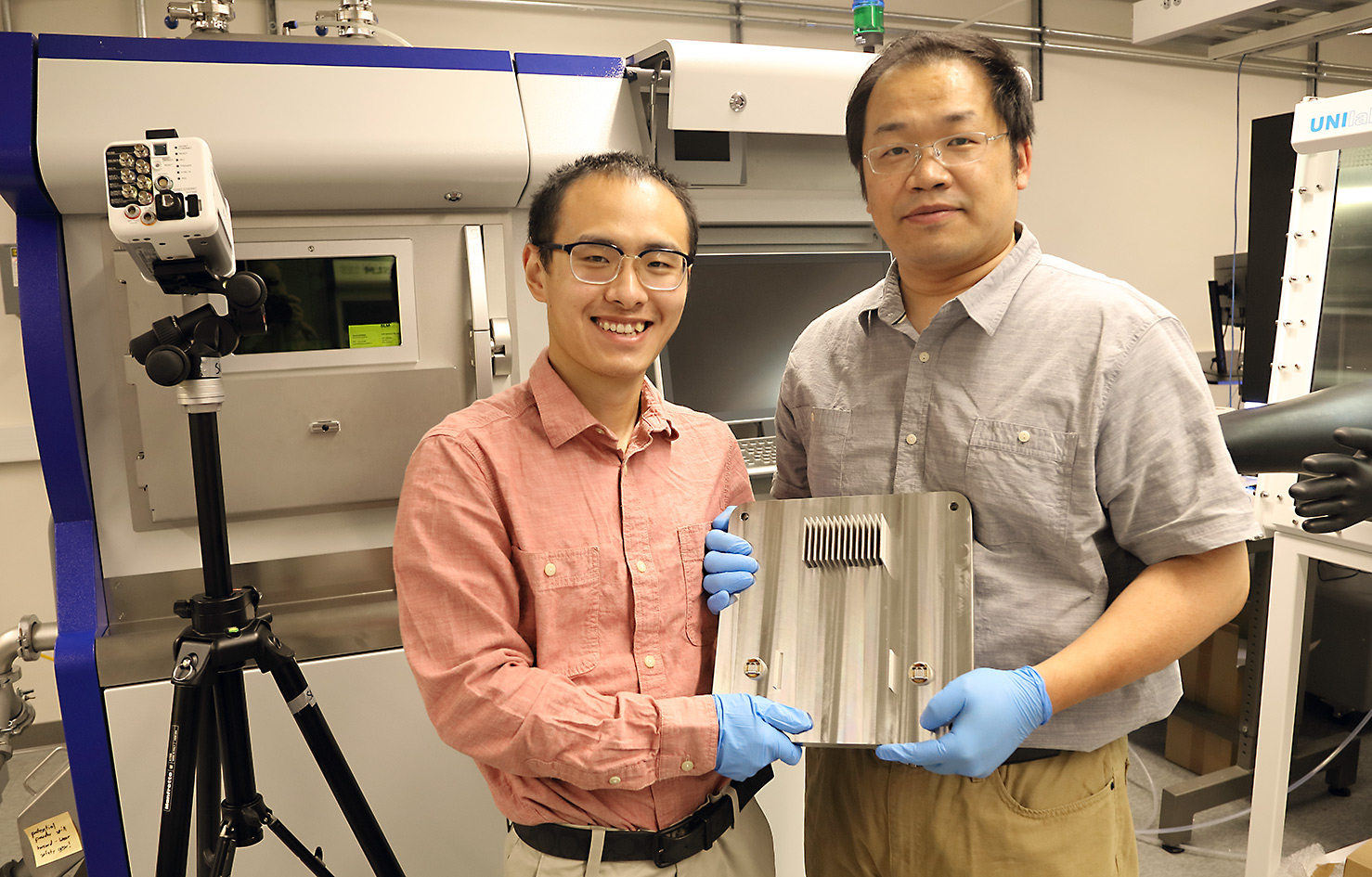 UVA materials science and engineering postdoctoral fellow Zhongshu Ren, left, and Tao Sun display the results of their research. Ren is the first author of the Science journal article.