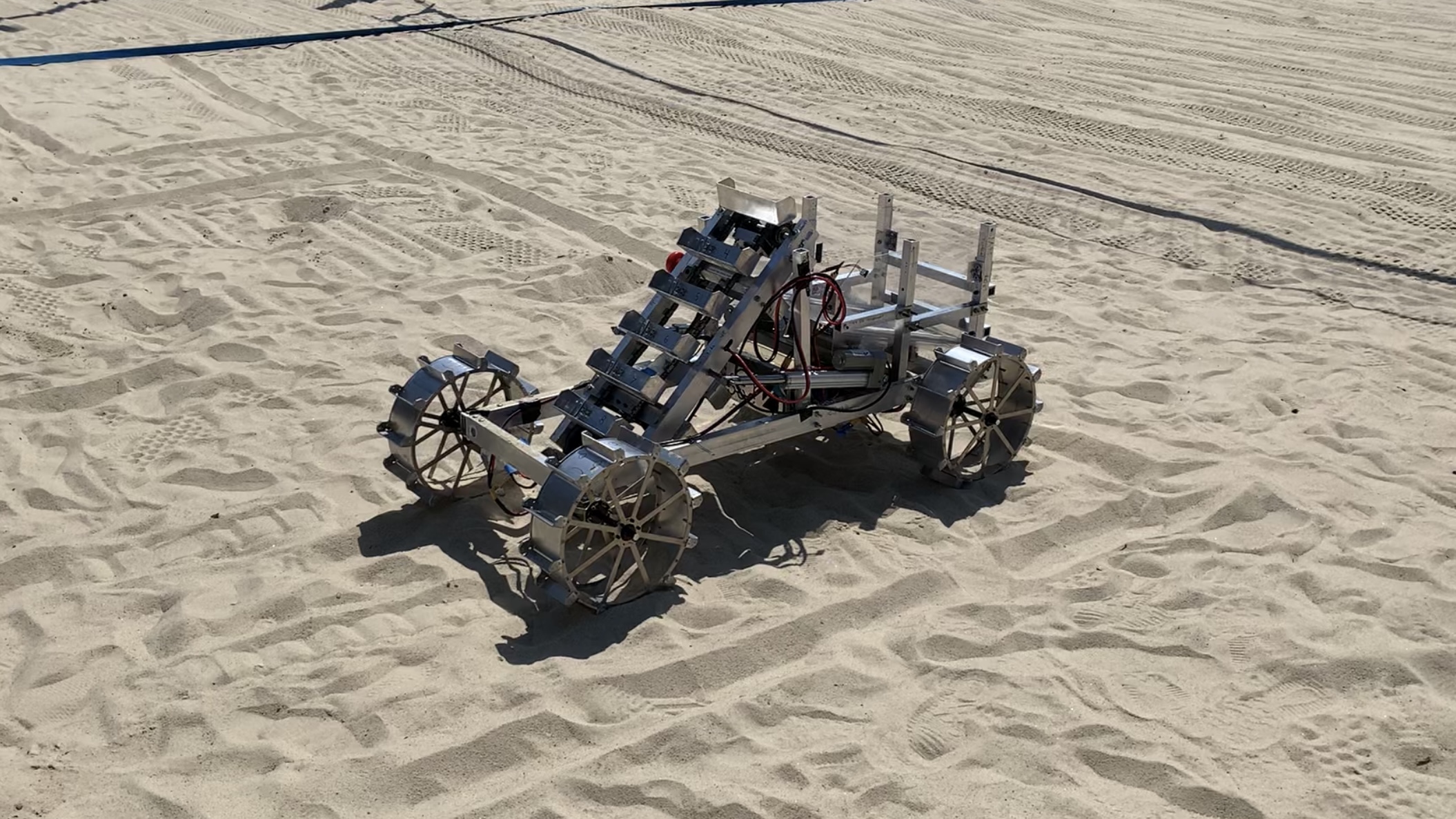 A MARS robot practices in the sand of a volleyball court for the 2024 competition.
