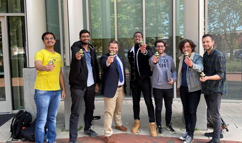 students with golden duck trophies