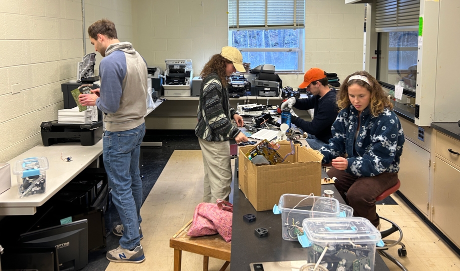 Printers 4 Kidz volunteers work on circuits and motors salvaged from old printers and other electronics that will be reused in STEM kits for local schools.