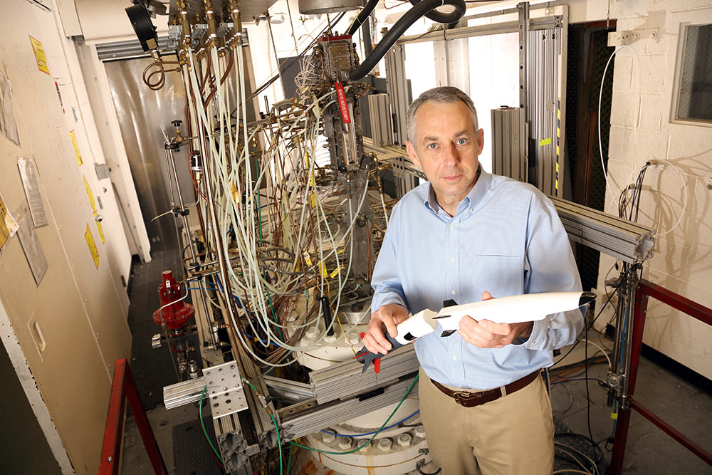 Professor Christopher Goyne in front of the test section of the supersonic combustion facility