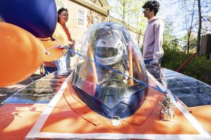 A student in the driver's seat of the UVA Engineering solar car
