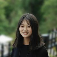 Image of woman smiling outside wearing a black shirt