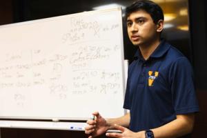 image of student wearing navy blue polo shirt with virginia cyber logo
