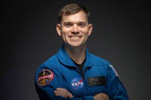 Portrait of Ben Bailey wearing a NASA jumpsuit