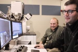 Zach Harris and Eric Hoglund work on the Helios FIB