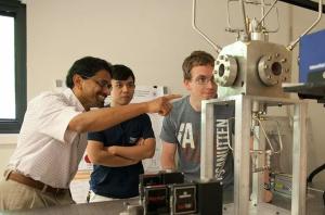 An instructor with several students in a mechanical engineering lab