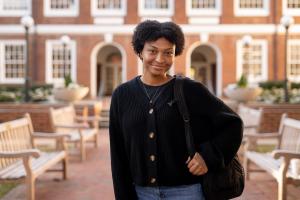 Student standing in front of Thornton Hall