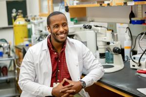 Prof. Dan Abebayehu seated at a lab bench