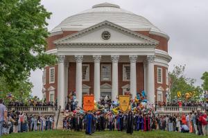 Students and faculty walking the Lawn at Final Exercises with the Rotunda in the background