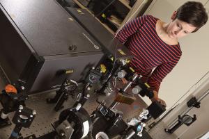 Chloe Dedic adjusts equipment in her lab