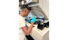 High school student working chemical engineering in lab
