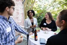 Graduate students gathered around a table at an awards event