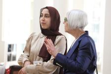 a younger and older woman talk