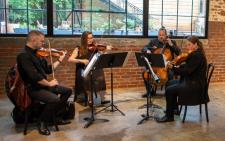 A four-piece string band playing