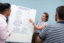 A student points out a feature of a poster