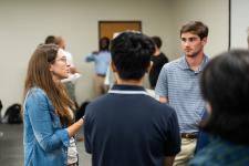 students discuss their projects with faculty