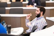 an audience member asks a question during a presentation