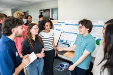 Students and visitors talk at the expo