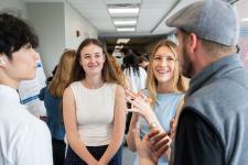 Students and visitors talk at the expo